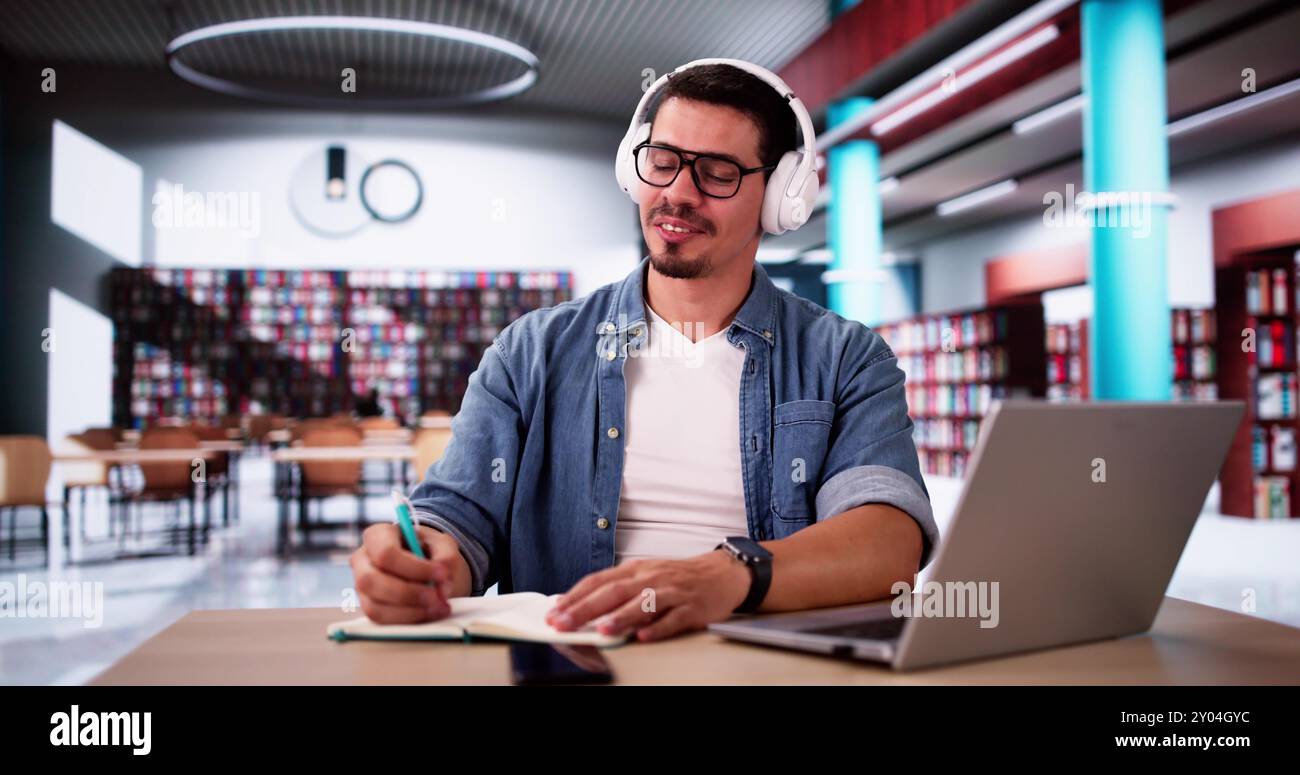 Student Man Thinking At Library While Using Univercity Laptop Stock Photo