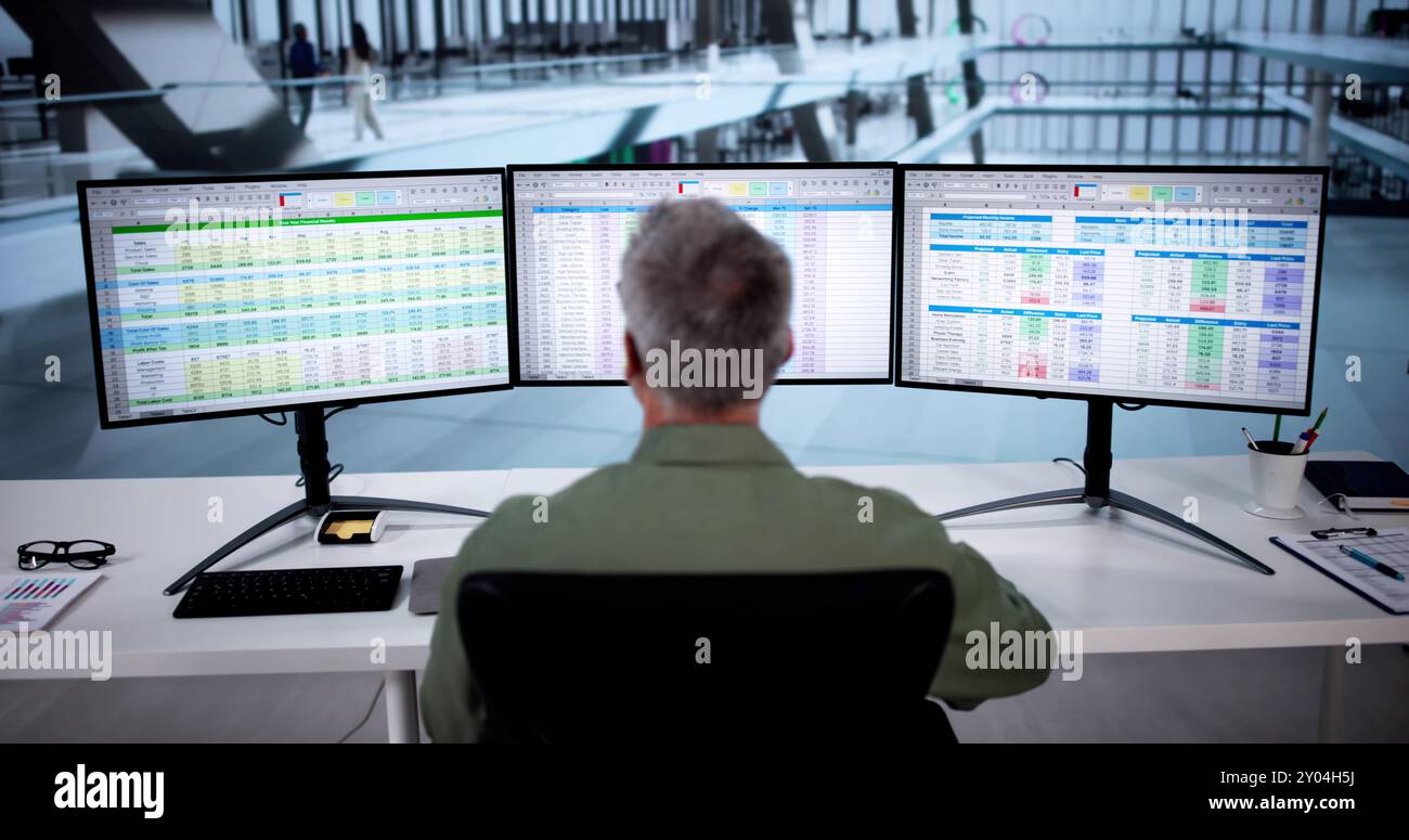 Analyst Working With Spreadsheet Business Data On Computer Stock Photo