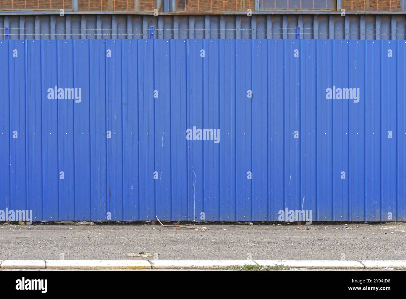 Corrugated steel metal blue fence exterior Stock Photo - Alamy