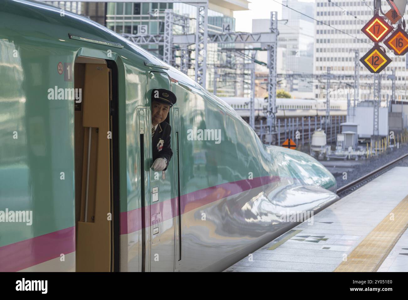 Tokyo, Japan, December 23, 2014: A Shinkansen train operator looking out of the window before departure, Asia Stock Photo