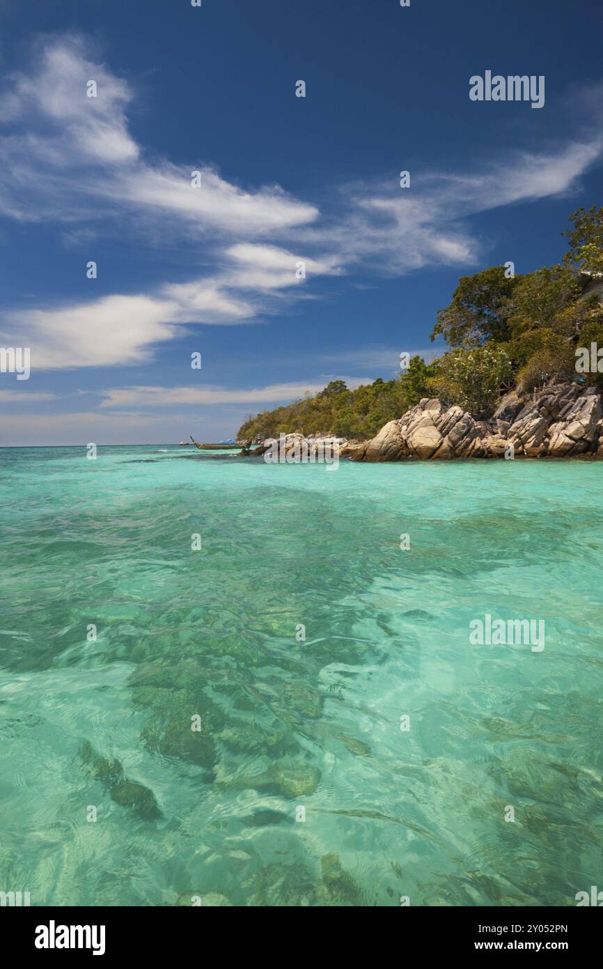 Faint coral in perfect crystal clear turquoise blue water meets the ...