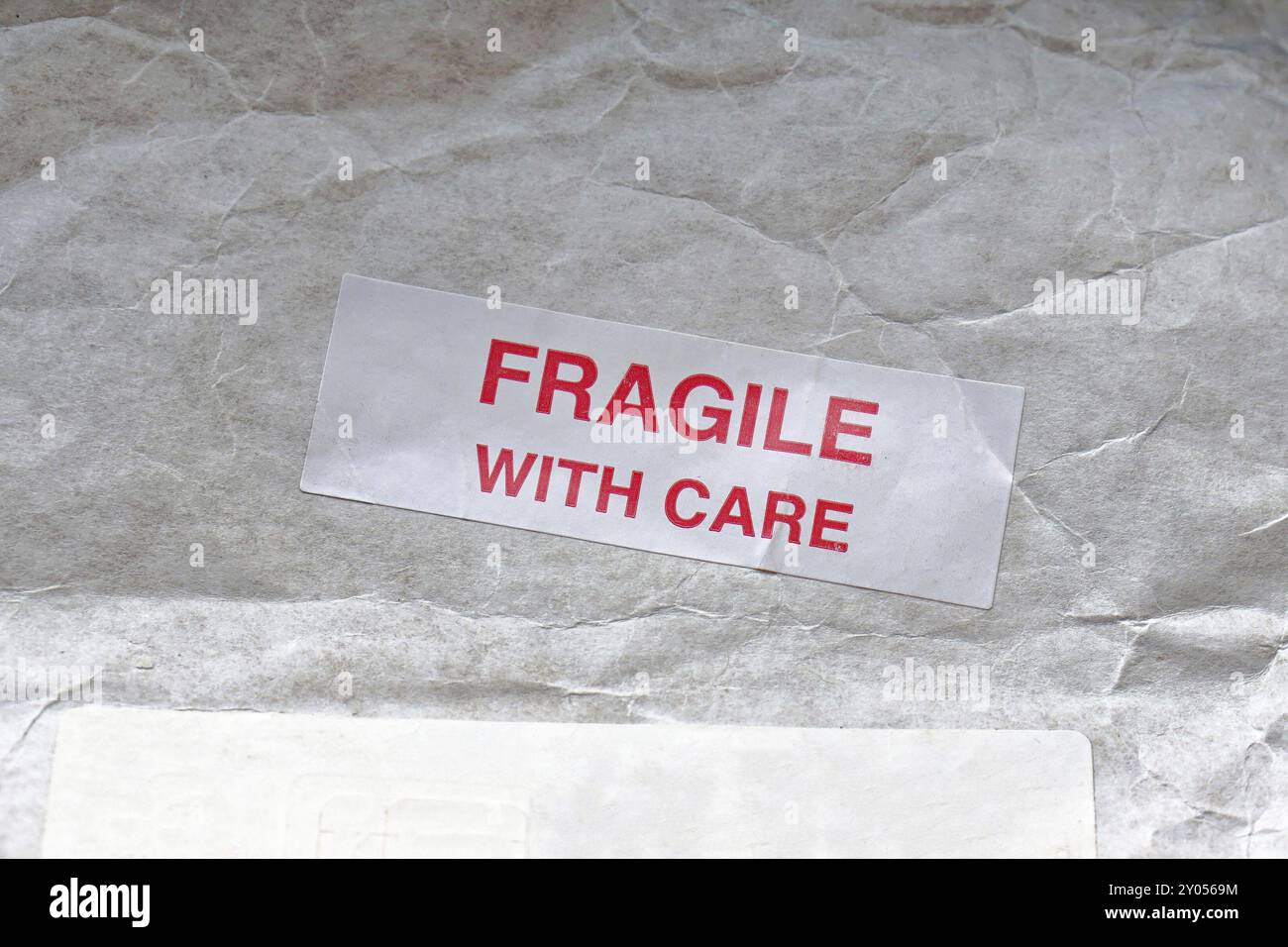 Fragile with care sticker at mail post Stock Photo