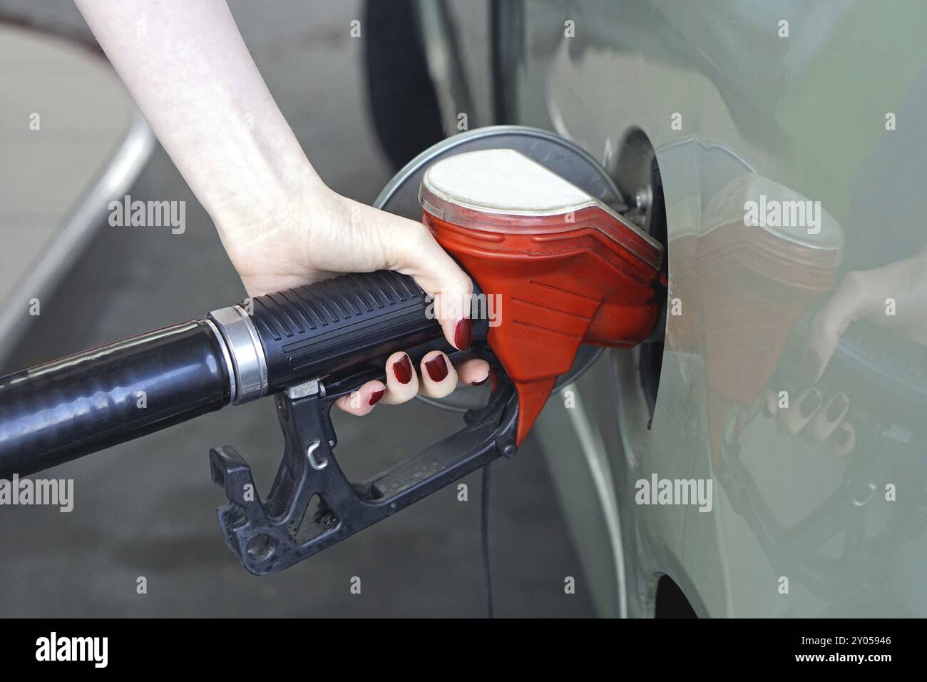 Woman filling car with gas at petrol station Stock Photo - Alamy