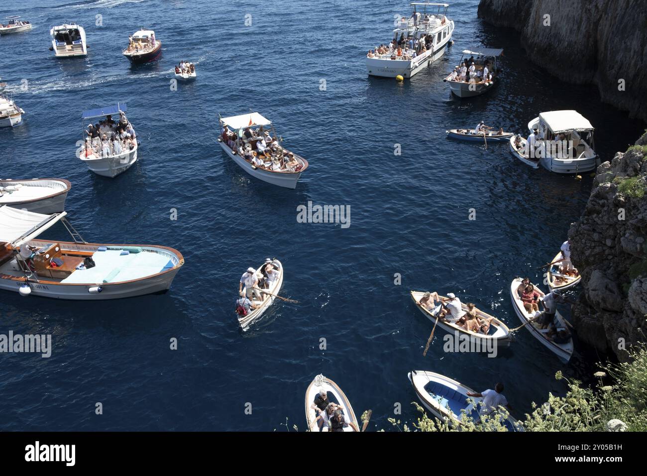 Italy, Gulf of Naples. Island of Capri, Blue Grotto. Boats with tourists in front of the entrance to the Blue Grotto, Capri, Campania, Italy, Europe Stock Photo