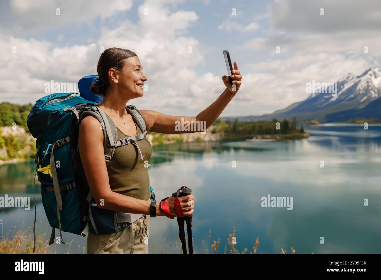 An Adventurous Female Hiker Happily Taking a Selfie Near the Beautiful ...
