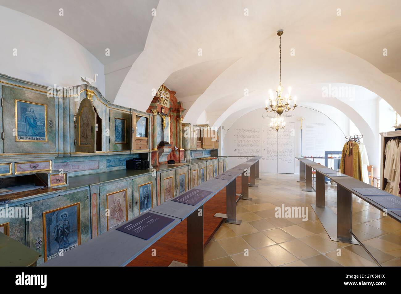 Eisenstadt, Burgenland, Austria. Eisenstadt Mountain Church (Haydn Church). The sacristy of the mountain church. Wooden tall cupboard with painted images of saints Stock Photo