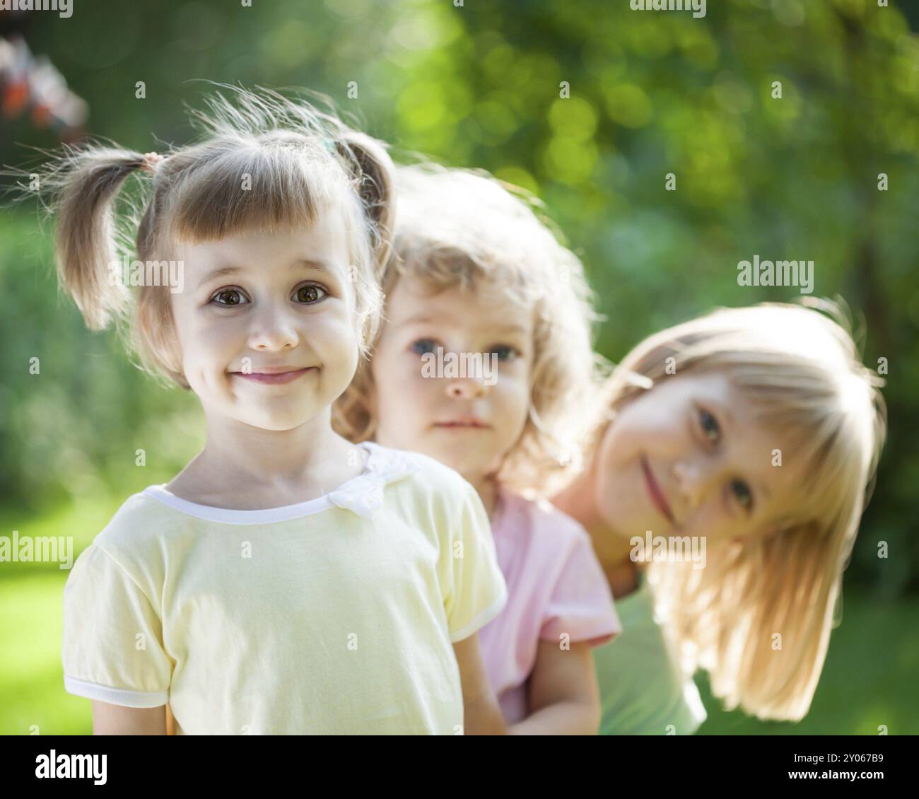 Group of happy children playing outdoors in spring park Stock Photo - Alamy