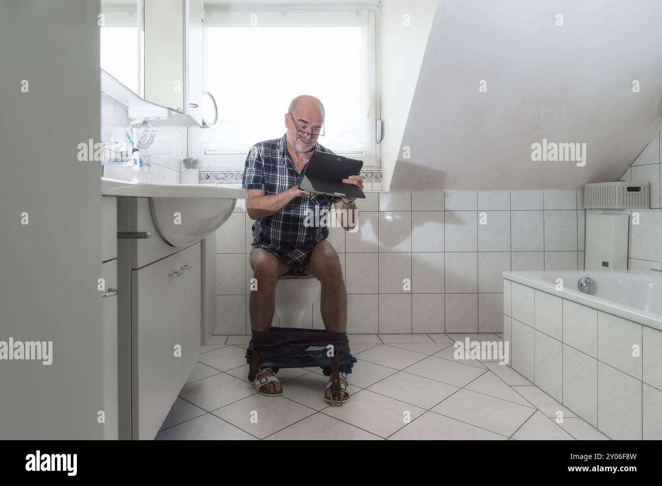 Man sitting on toilet hi-res stock photography and images - Alamy