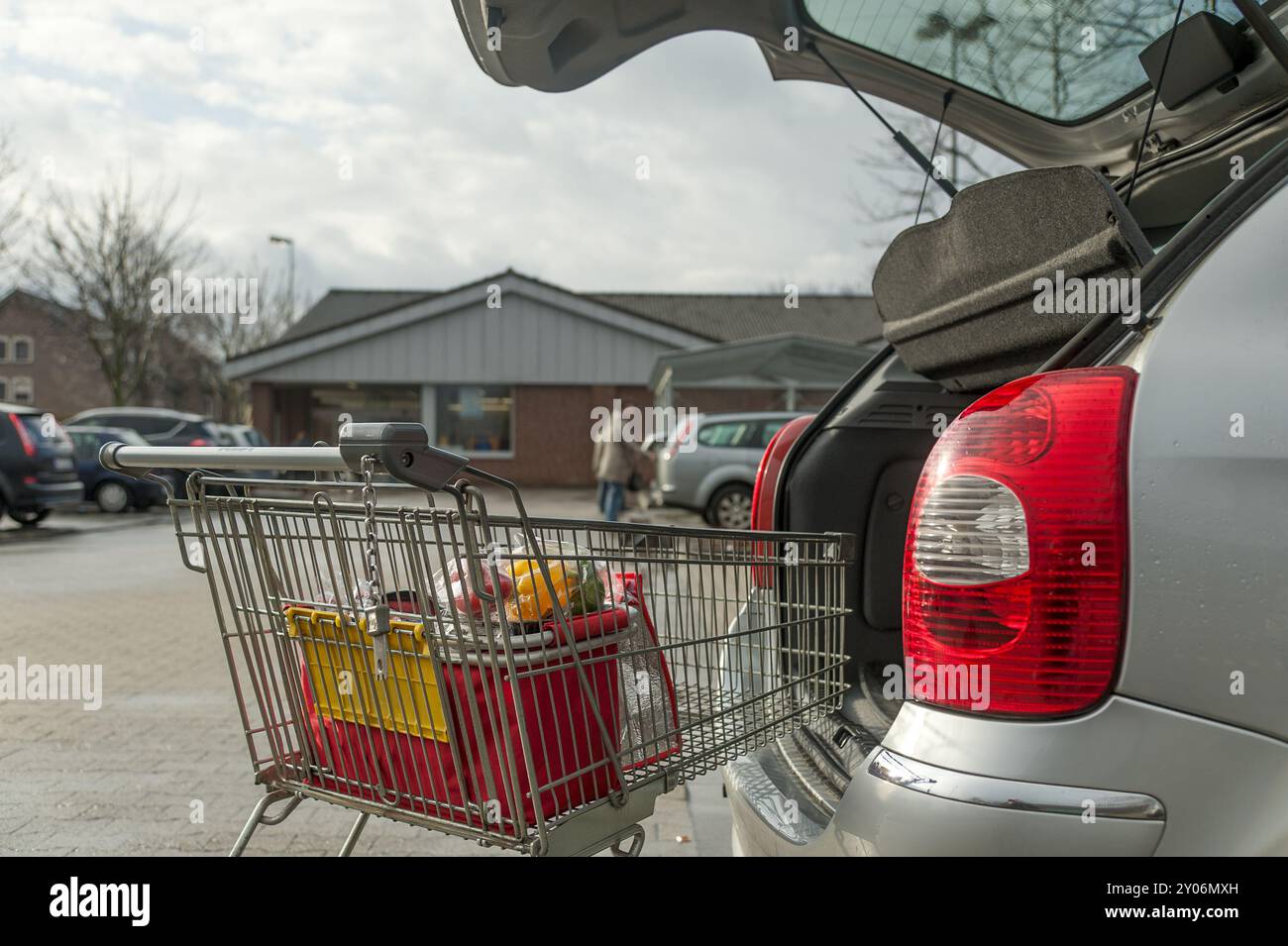 Shopping trolley on the tailgate of a car Stock Photo