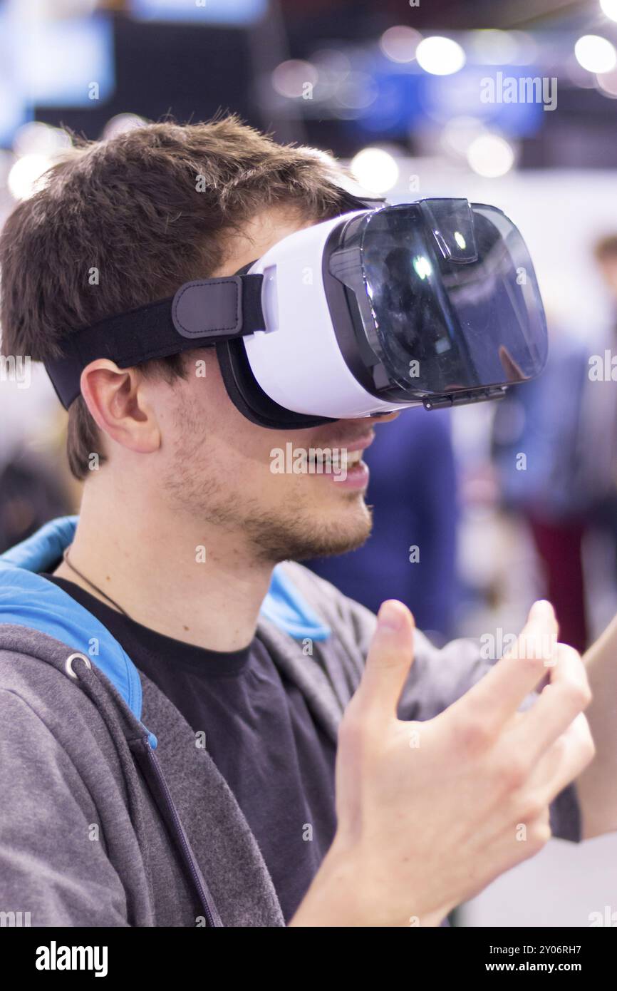 Young man is using virtual reality glasses on an expo Stock Photo