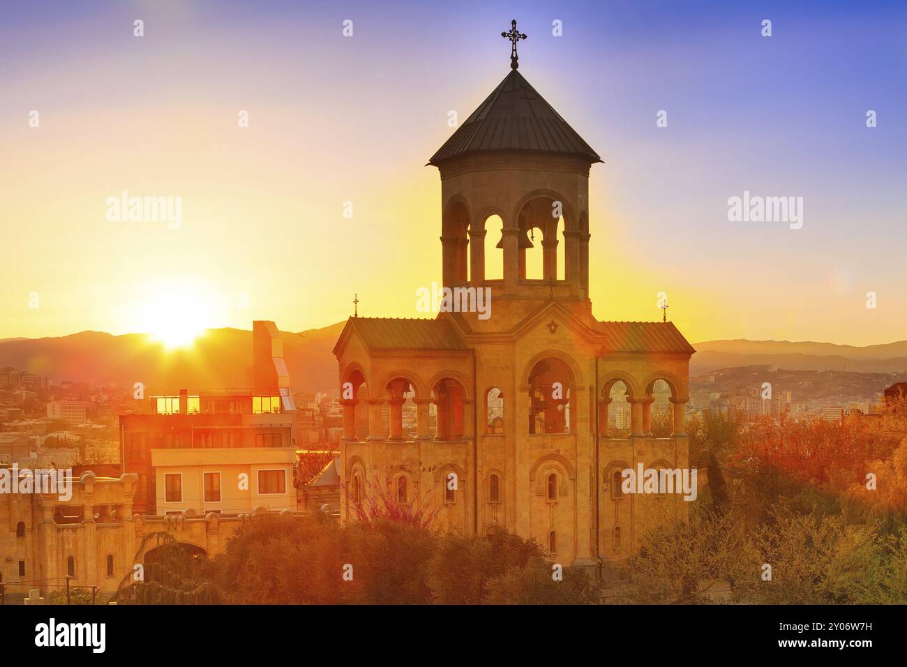 Bell tower of Holy Trinity church or Tsminda Sameba Cathedral sunset ...