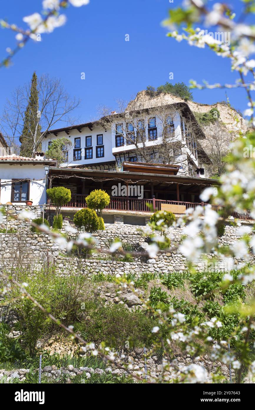 Traditional stone built house in Melnik town, Bulgaria and spring flowers blossom Stock Photo