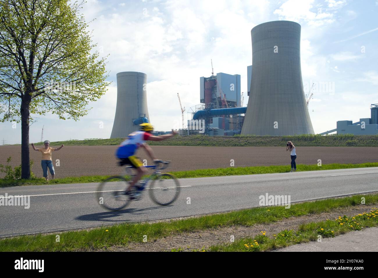 Single cyclist in front of a power station Stock Photo - Alamy