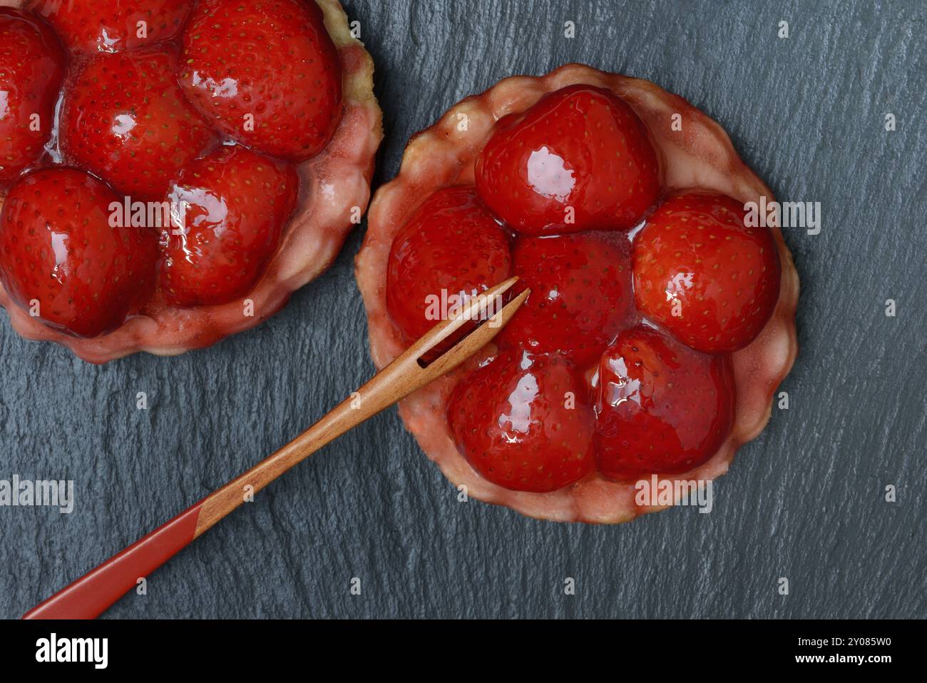 Topped strawberry tarts with a fork Stock Photo
