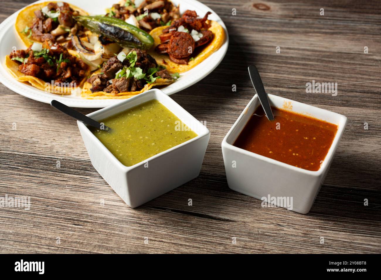 A view of square condiment cups of Mexican salsas. Stock Photo
