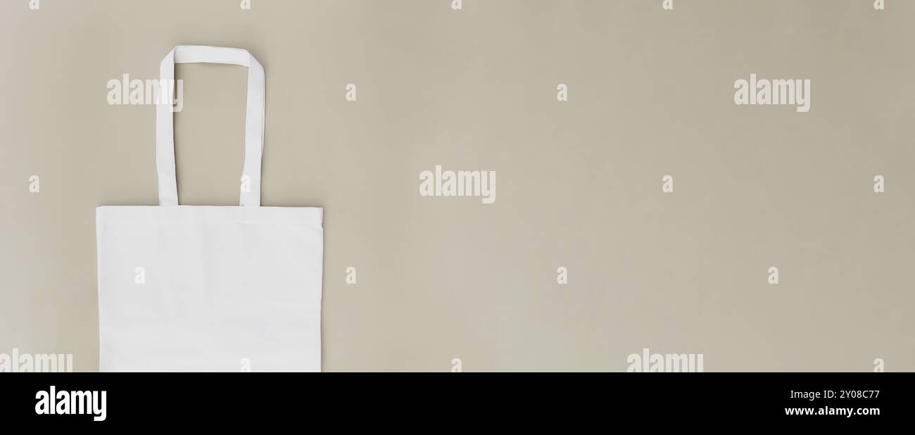 Eco white craft paper bag flat lay banner on beige background with copy space empty advertising area. Packaging template mock up. Delivery service, re Stock Photo