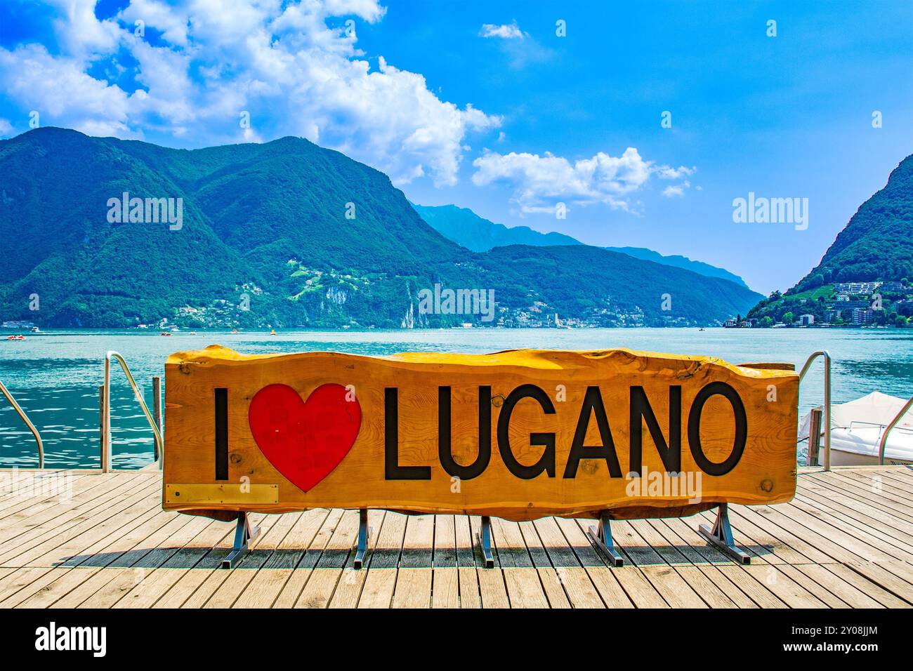 Lugano lake shore in Switzerland, inscription engraved on wood says I love Lugano with a red heart Stock Photo