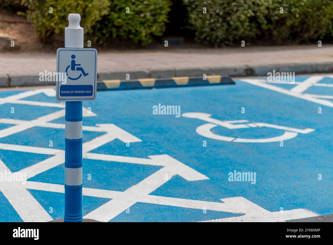 Blue painted disabled wheelchair parking at a parking. Stock Photo