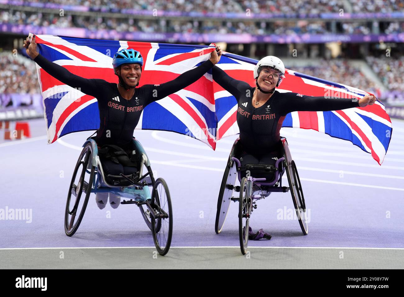 Great Britain's Hannah Cockroft (right) celebrates winning gold and Kare Adenegan celebrates winning silver in the Women's 100m T34 Final at the Stade de France on day four of the Paris 2024 Summer Paralympic Games. Picture date: Sunday September 1, 2024. Stock Photo