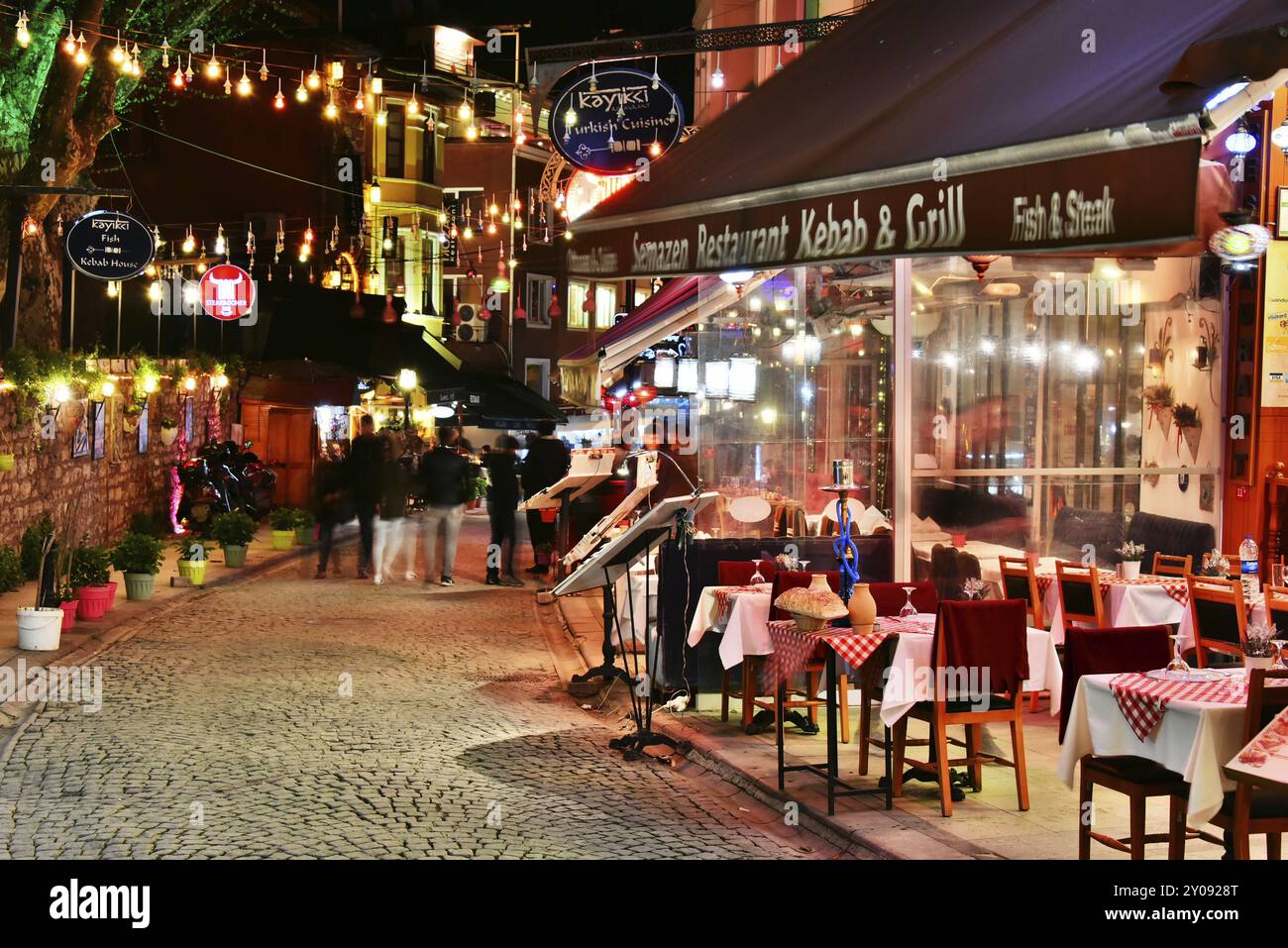 ISTANBUL, TURKEY, APR 24, 2017: Restaurants are great touristic attraction and important part of nightlife in the neighborhood area of Sultan Ahmed Mo Stock Photo