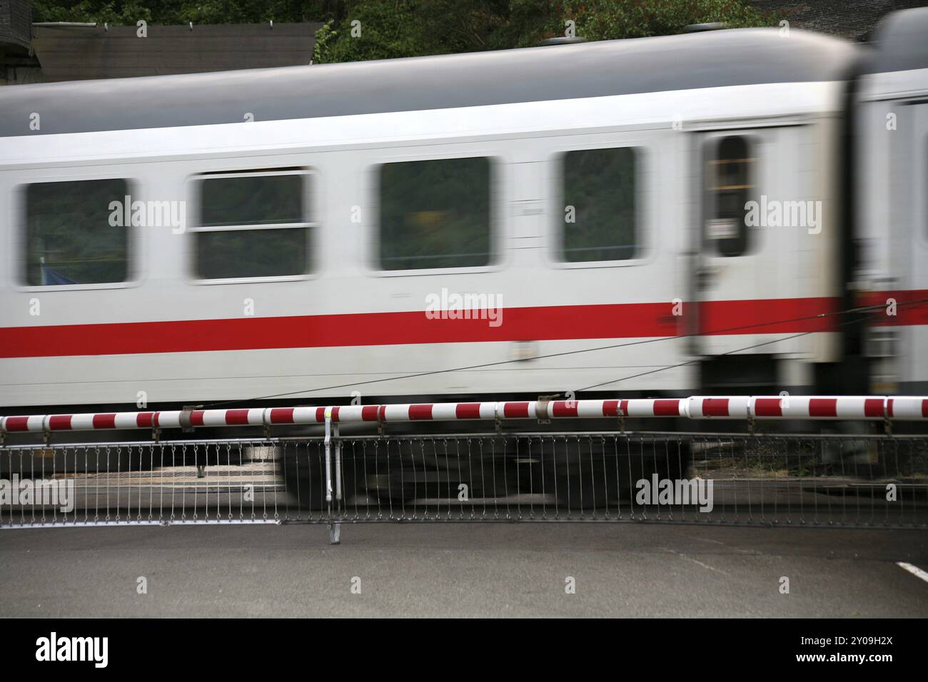 Rushing train with barrier Stock Photo - Alamy