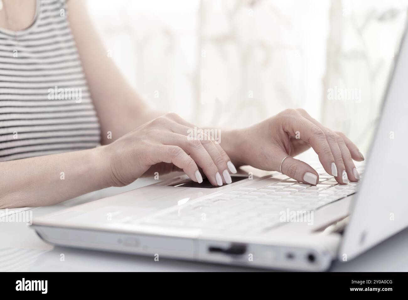 Close up of female hands using modern computer, high key. Blogger concept Stock Photo