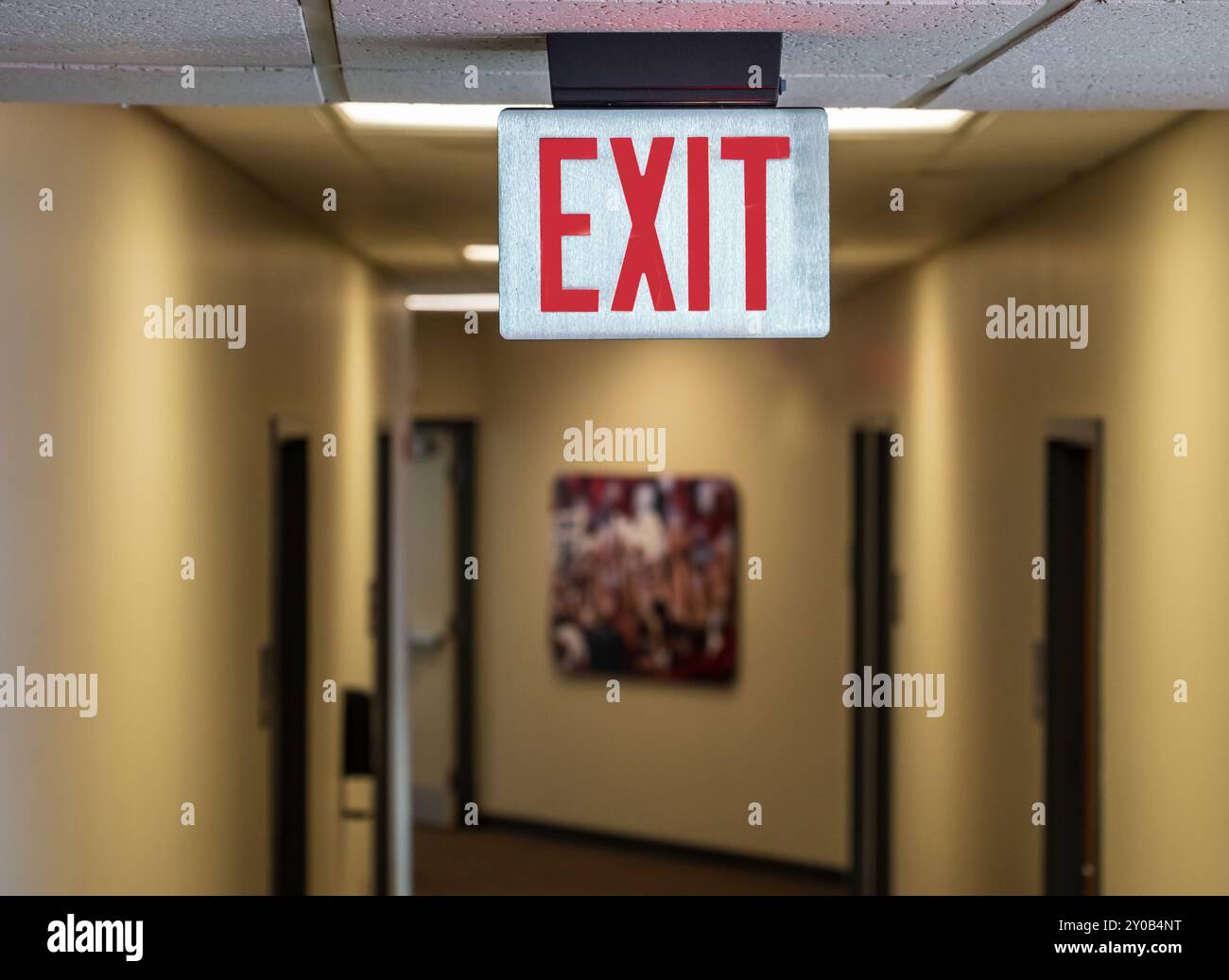 Emergency exit sign over hallway Stock Photo