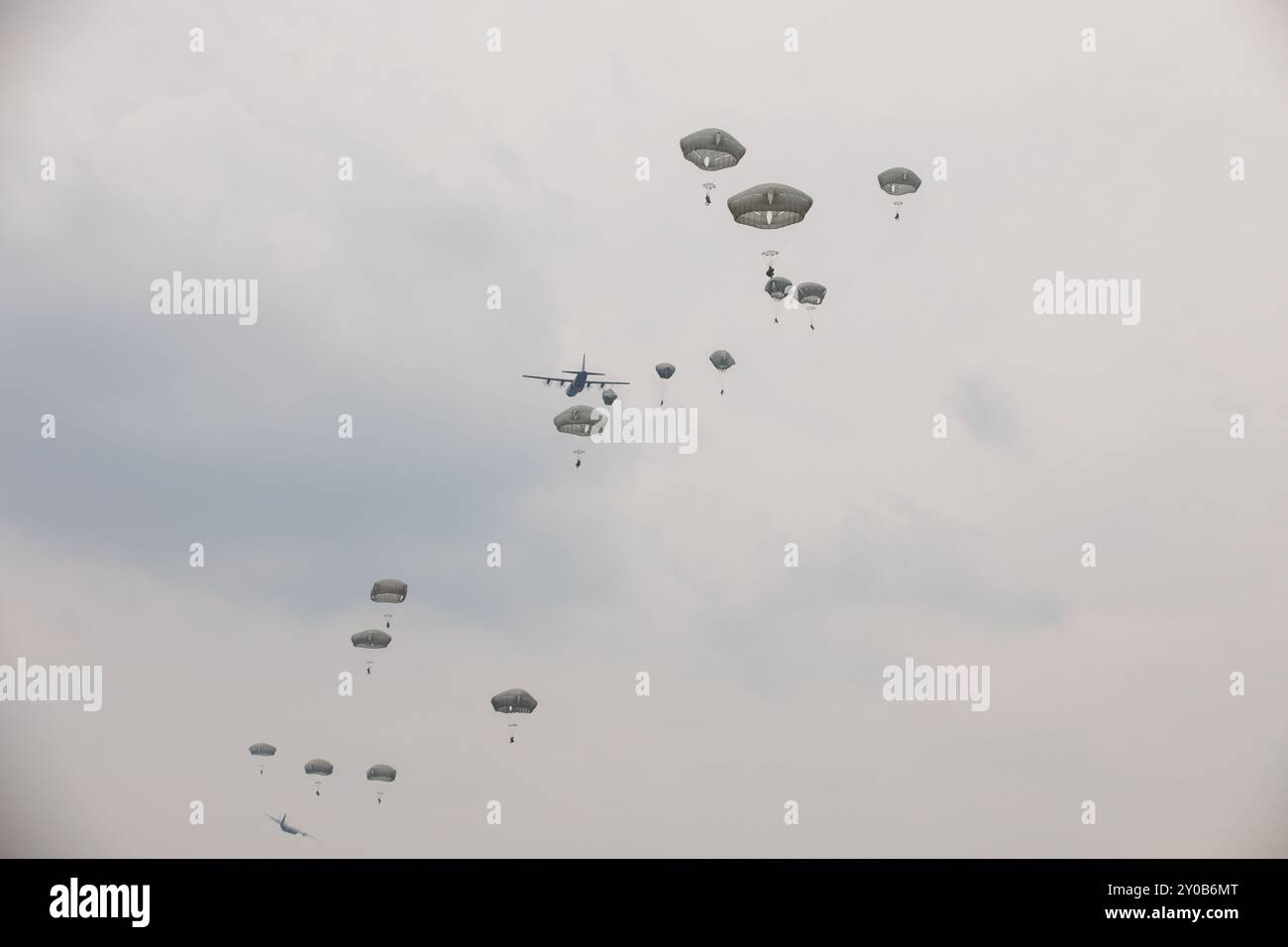 U.S. Army Soldiers with Bison Troop, 1st Squadron, 40th Cavalry Regiment drop from the sky during Super Garuda Shield 2024 in Indonesia, Aug. 29, 2024. Multinational airborne operations during Super Garuda Shield are essential for mission readiness as they enhance interoperability, foster seamless coordination among allied forces, and ensure rapid deployment capabilities. Super Garuda Shield is an annual exercise that has significantly grown in scope and size since 2009. Super Garuda Shield 2024 is the third consecutive time this exercise has grown into a combined and joint event focused on co Stock Photo