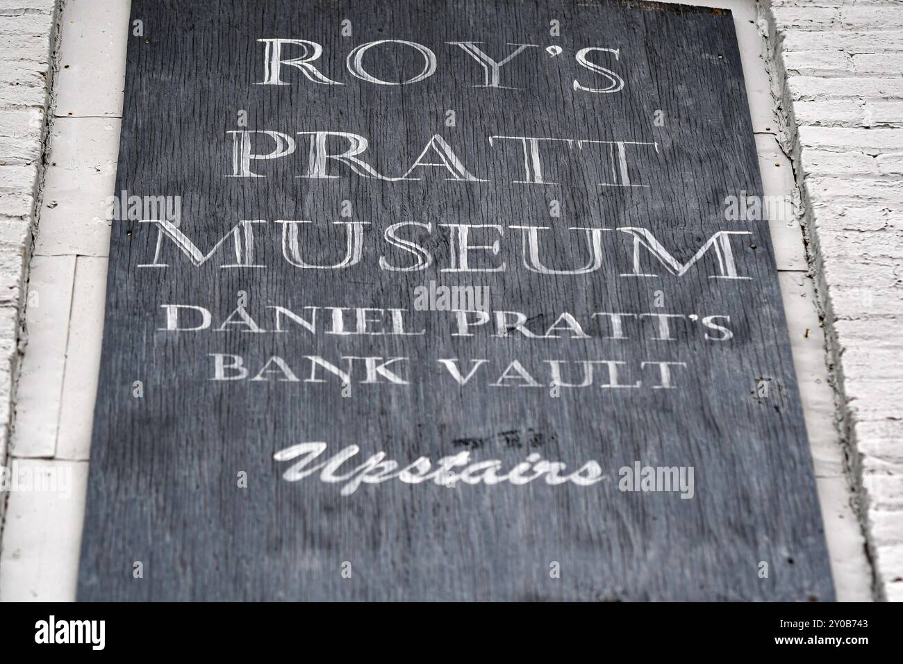 Prattville, Alabama, USA-March 5, 2024: Close up of the old wooden sign for Roy's Pratt Museum on the historic building that once housed Autauga Banki Stock Photo