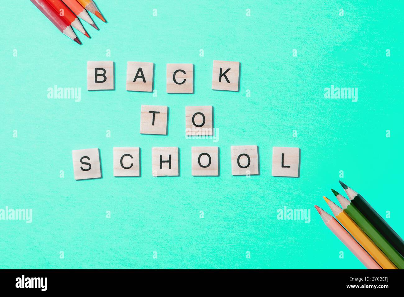 Flat lay, bright back to school concept on blue background. Stock Photo