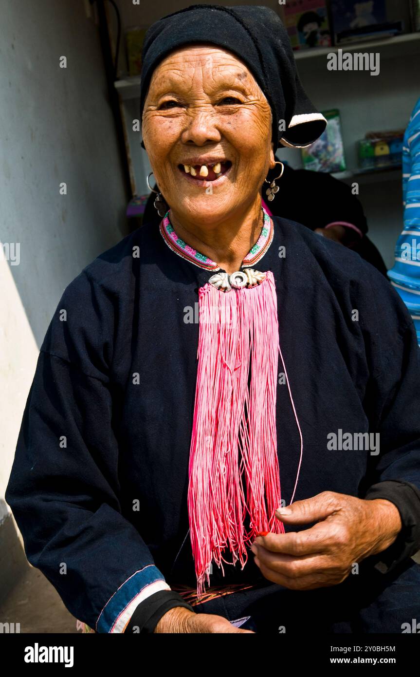 Portrait of a Black Yao woman taken at a colorful weekly market in southern Yunnan province ,by the border of Vietnam, China. Stock Photo