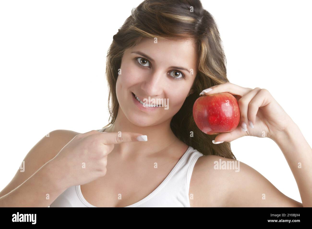 Woman smiling and pointing at a red apple she holds on her hand Stock ...