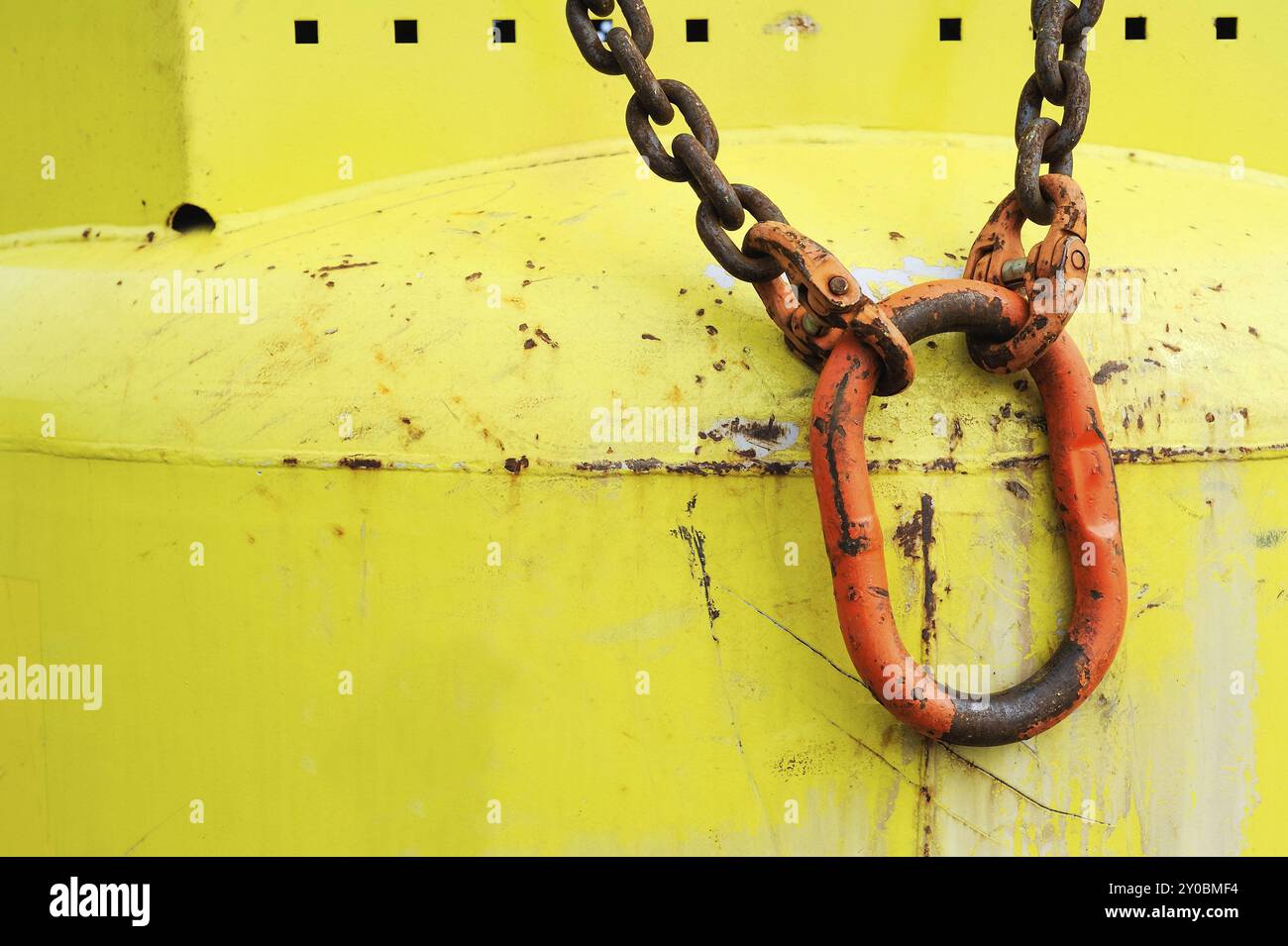 Red carabiner on yellow bottle Stock Photo
