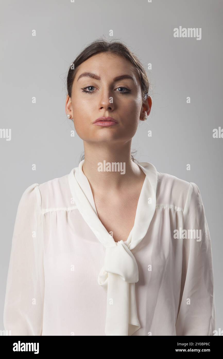 Strict looking woman on white Stock Photo