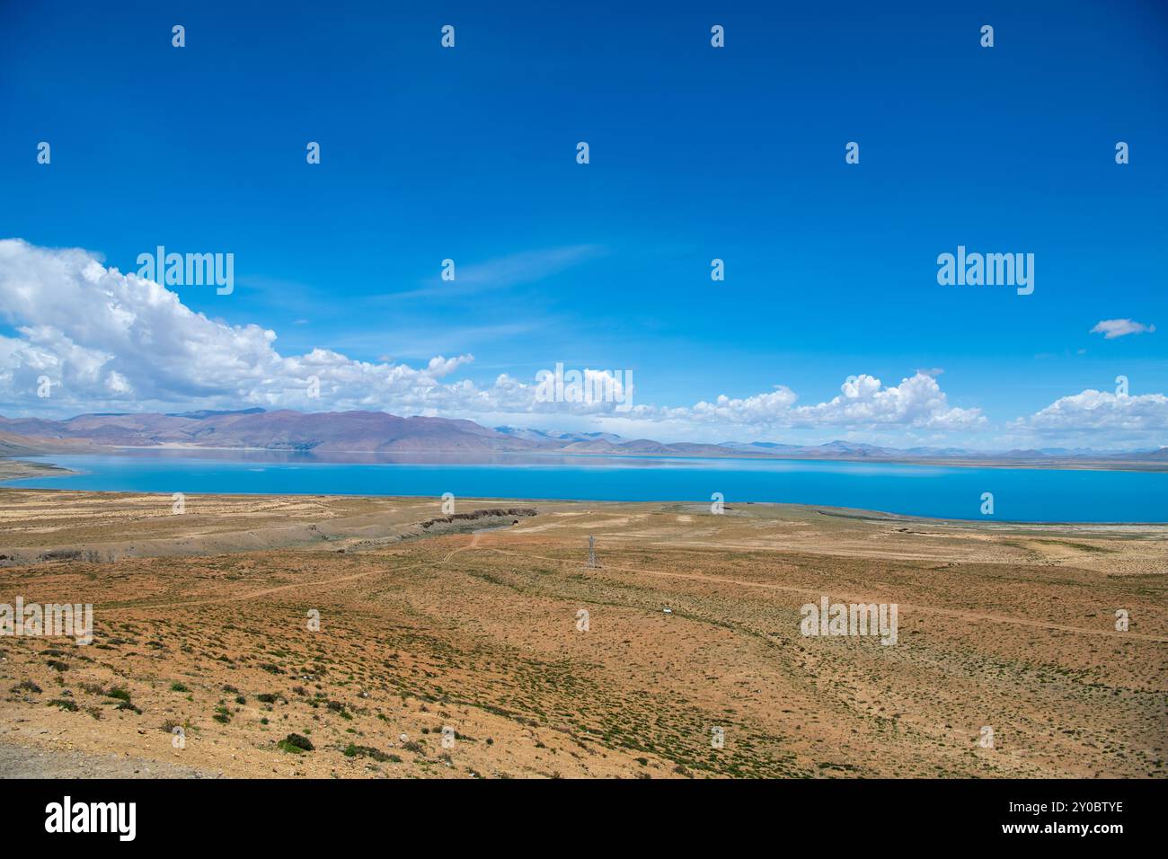 The sacred Manasarovar lake with blue transparent water in the mountains of Tibet under cloudy sky. Ngari scenery in West Tibet. Sacred place for Budd Stock Photo