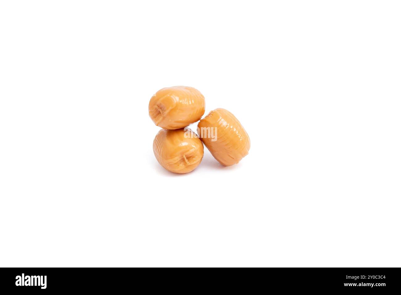 Three caramel candy drops piled up isolated on white Stock Photo