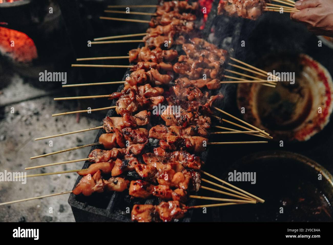 The process of making Indonesian chicken satay in traditional way using ...