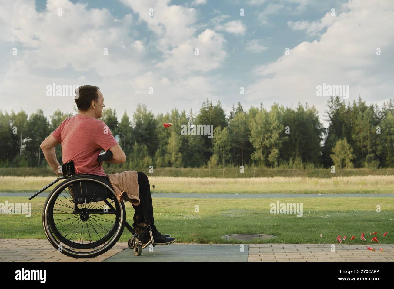 Man in wheelchair holding guns hi-res stock photography and images - Alamy