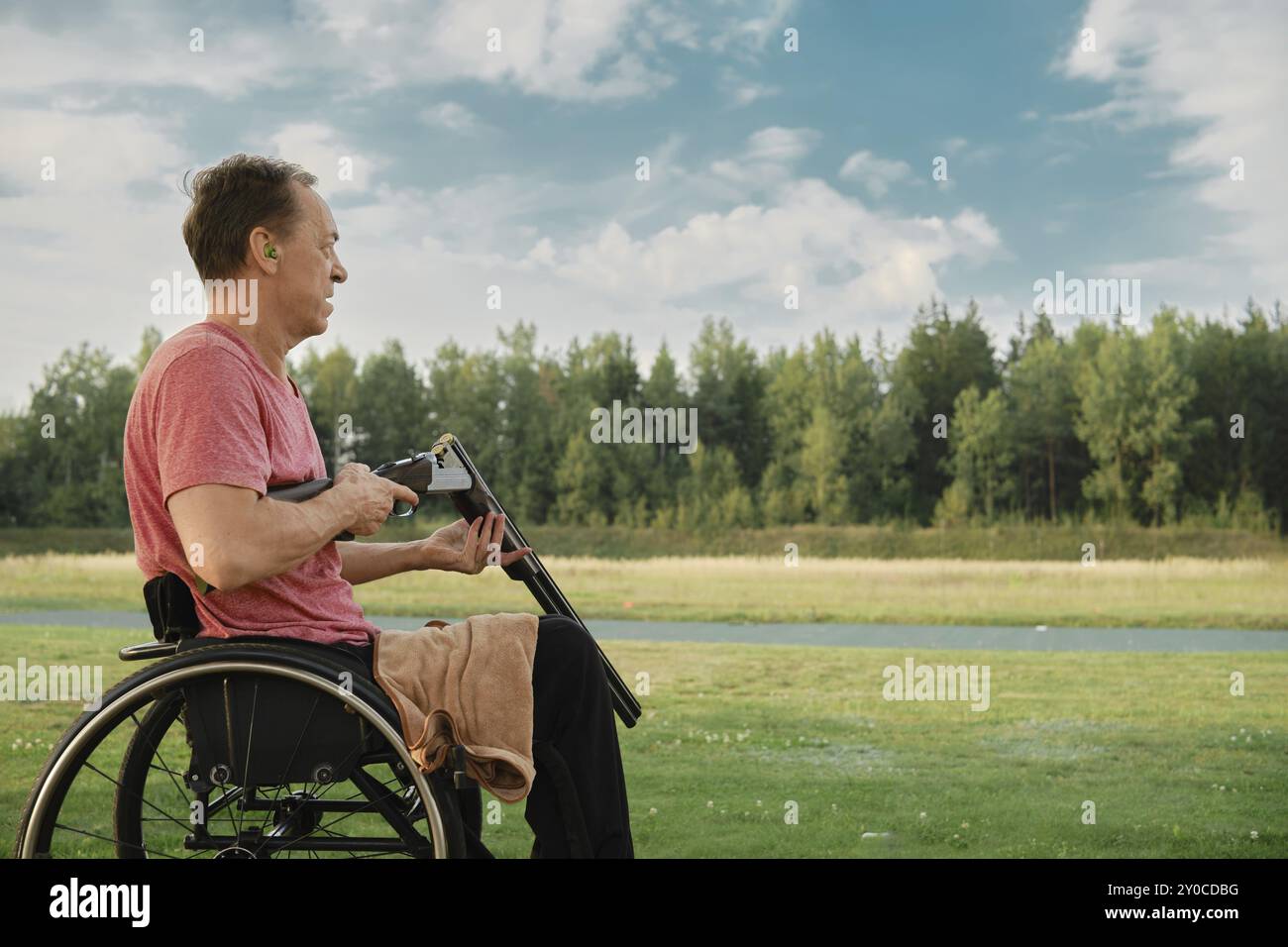 Man in wheelchair holding guns hi-res stock photography and images - Alamy