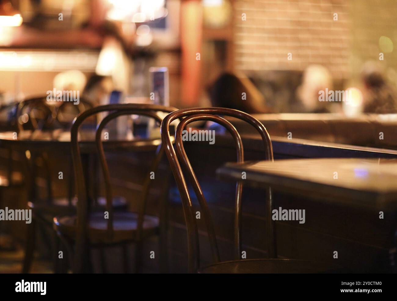 People in coffee shop blur background with bokeh lights, vintage filter for old effect Stock Photo