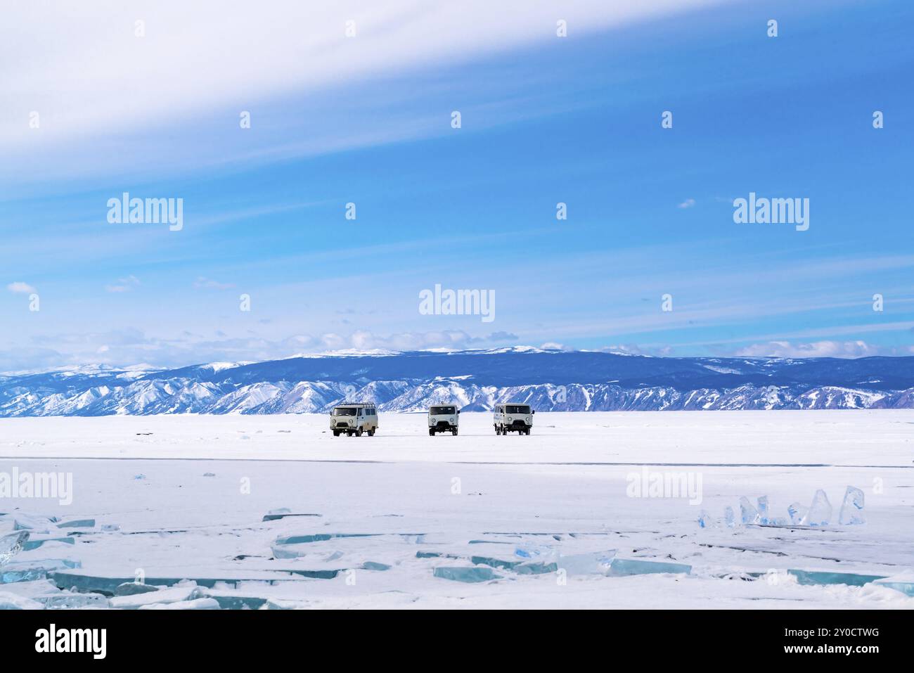 Grey cars stay on snowy surface of Frozen Lake Baikal in Russia Stock Photo