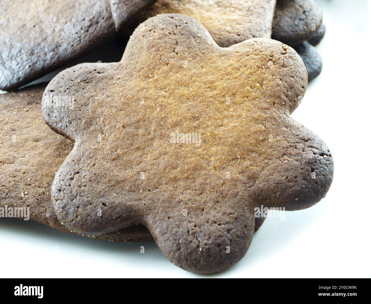 Burned gingerbread cookies on white plate towards white background Stock Photo