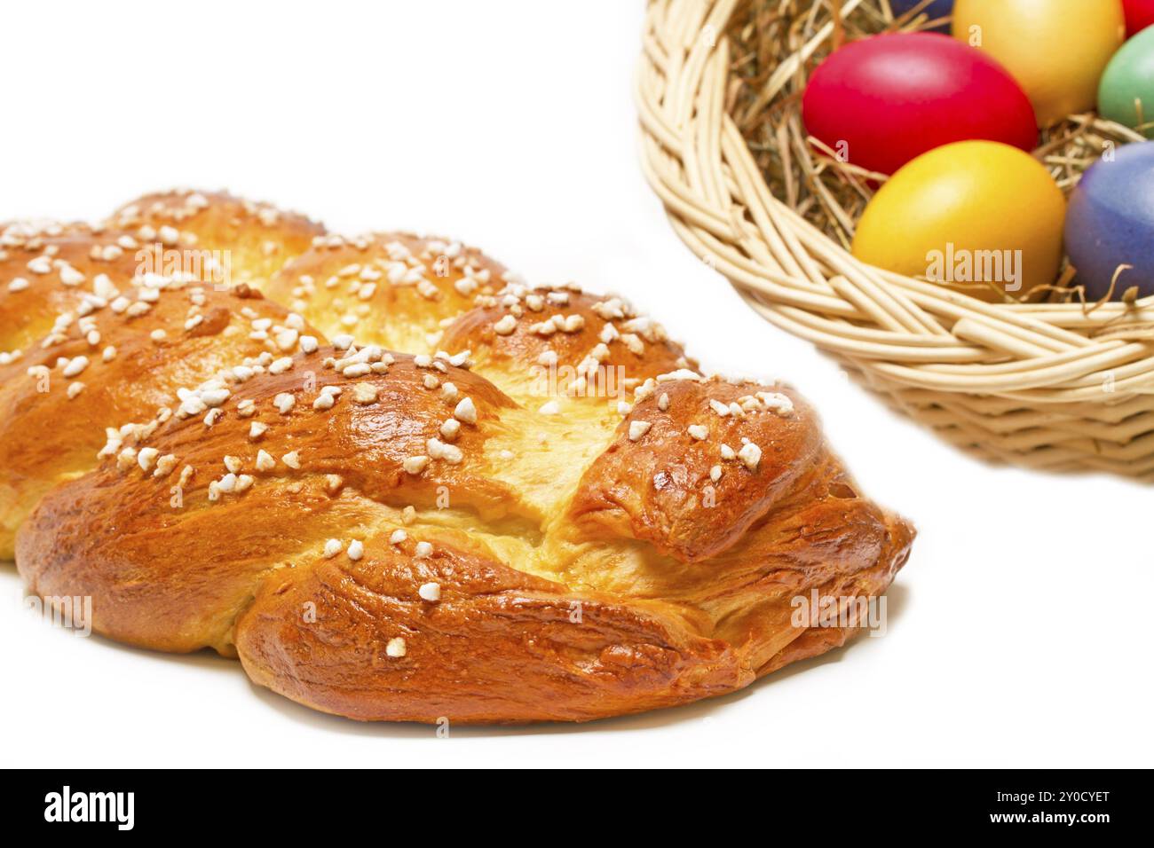 Home-baked yeast plait with colourful Easter eggs Stock Photo
