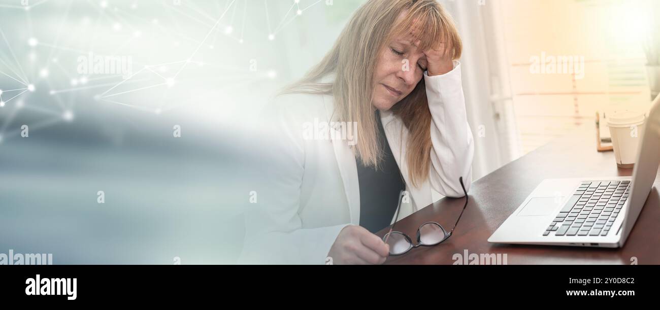 Stressed businesswoman sitting in office with hand on forehead ...