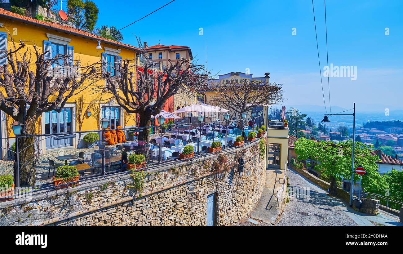 Via al Castello with a line of dense vintage colored houses, restaurants  and Bergamo - San Vigilio funicular station in background, Bergamo, Italy  Stock Photo - Alamy, image size:1300x819