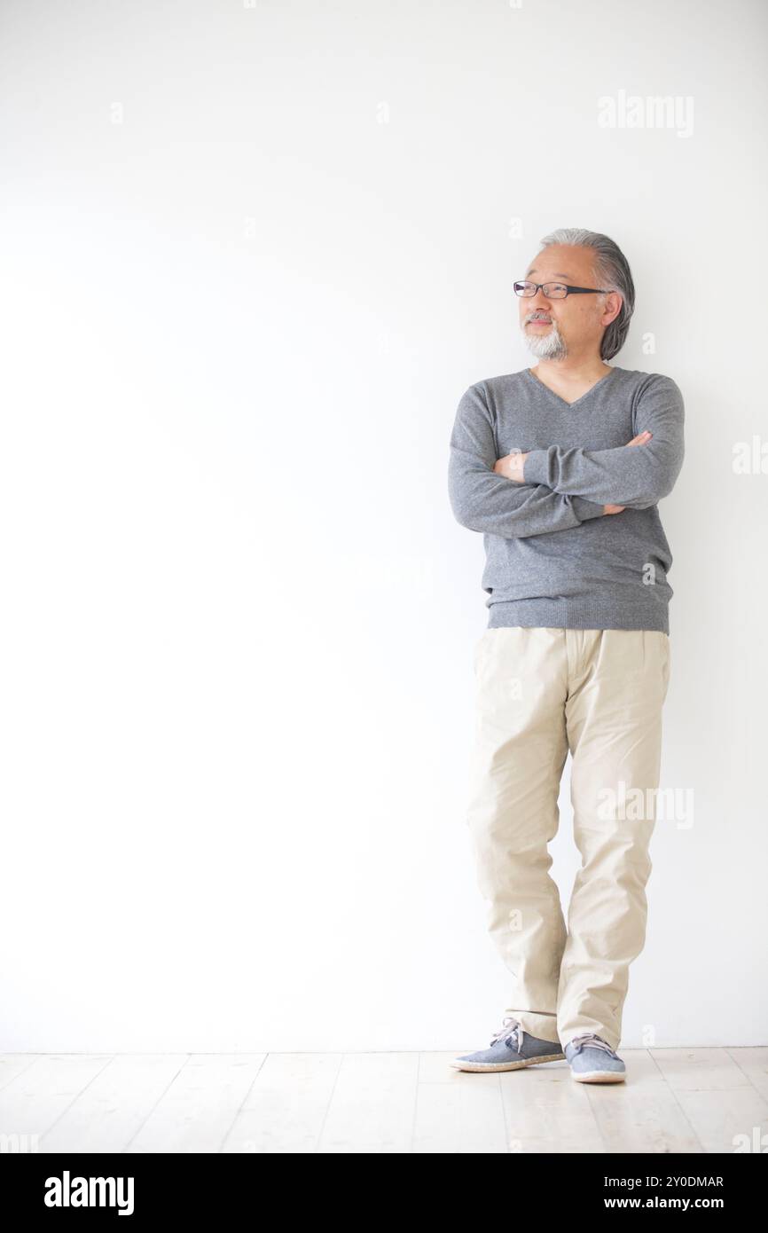 A senior man standing with his arms crossed Stock Photo - Alamy