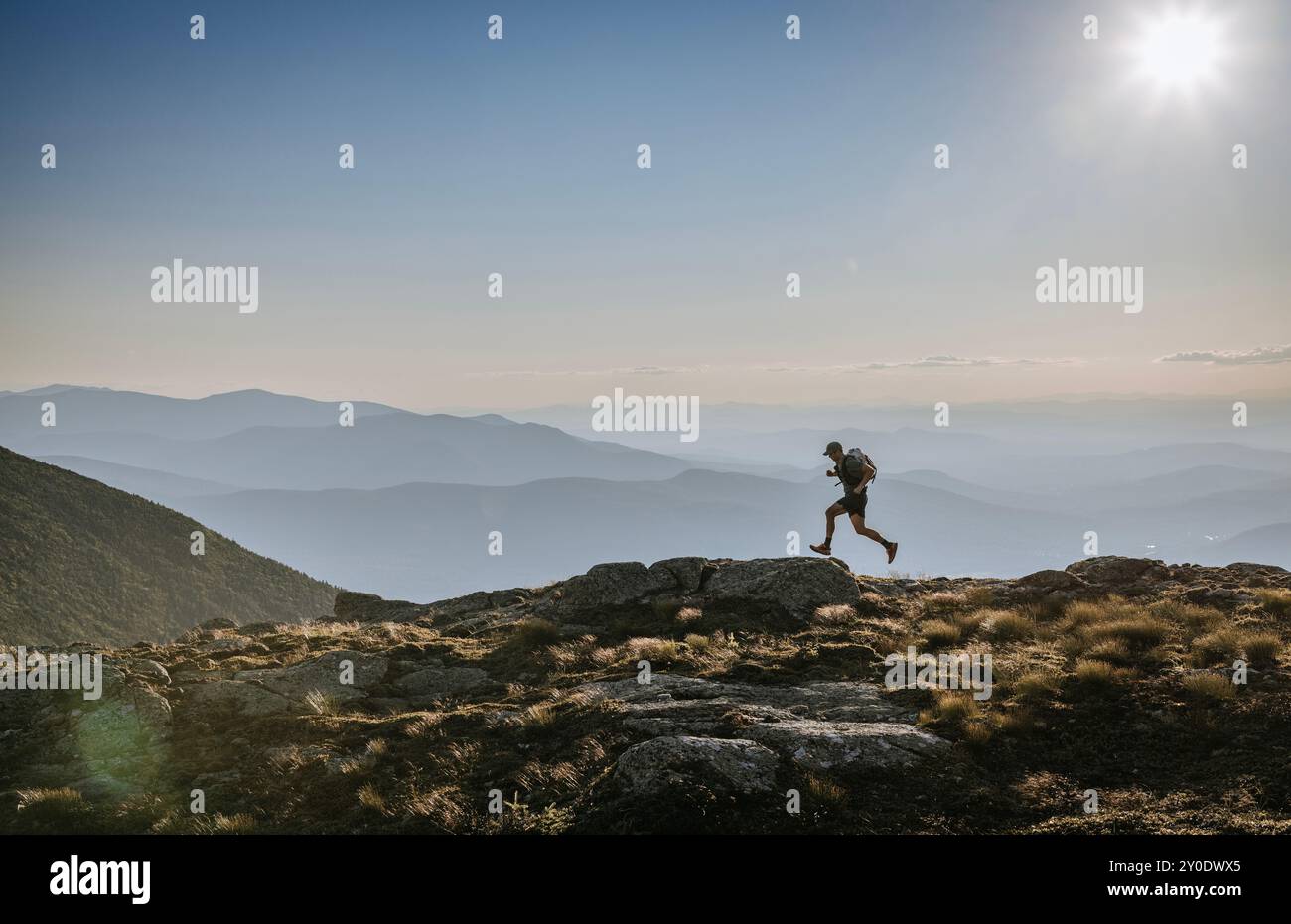Across Ridge Trail runner leaps across ridge high in White Mountains, NH Stock Photo ...