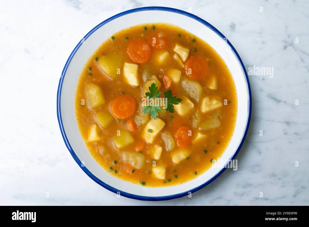 Squid stew with potatoes and vegetables. Top view table with decoration. Stock Photo