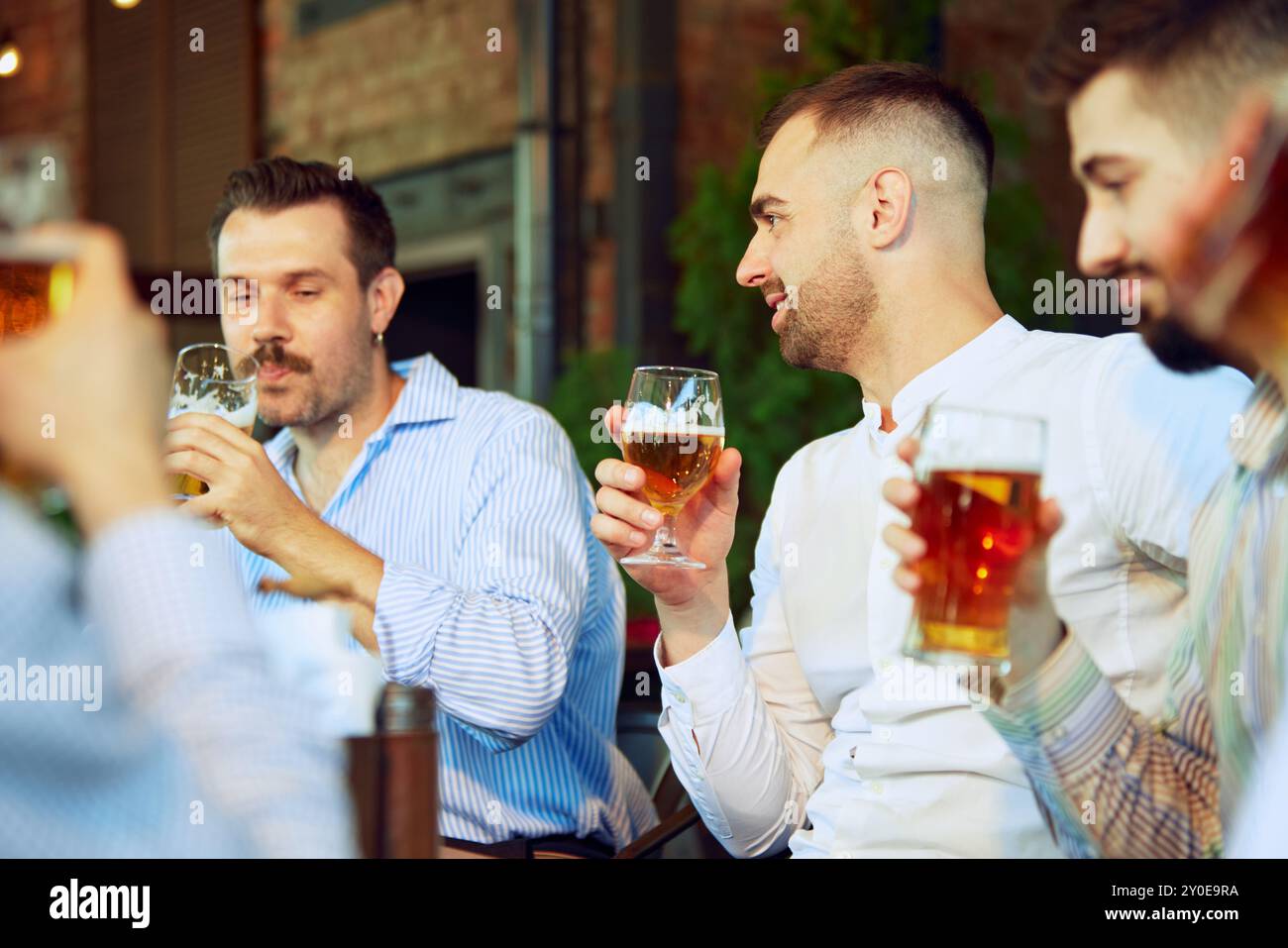 Beer Meating Productive meeting, businessmen in formal wear gathering at outdoor bar ...