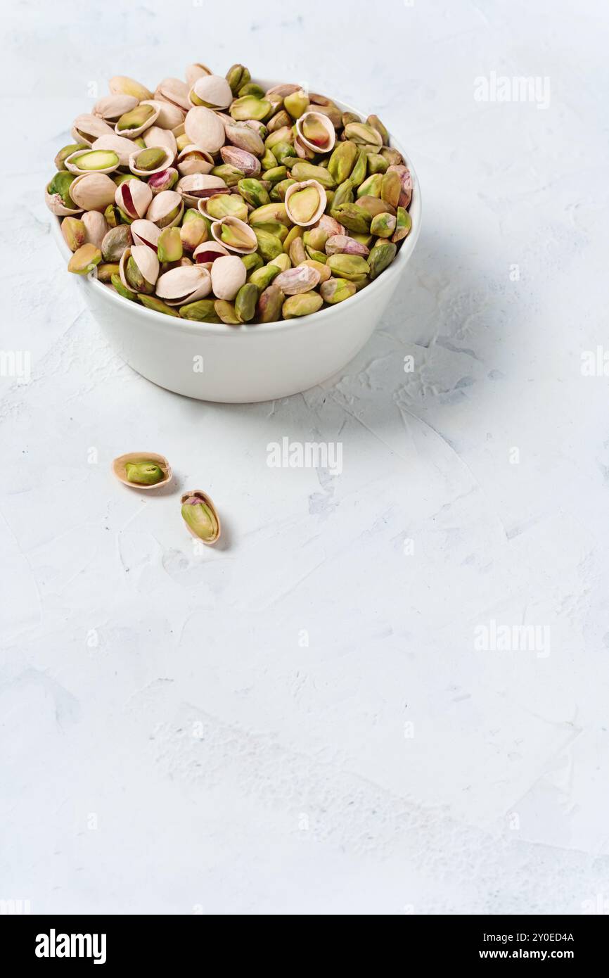 Assorted Pistachios In A Simple White Bowl Stock Photo